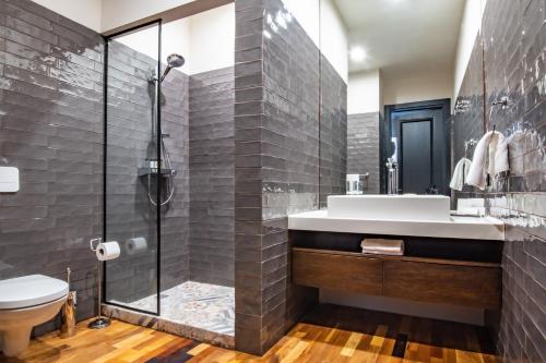 a bathroom with a shower and a sink at Warm House Apart Hotel in Almaty