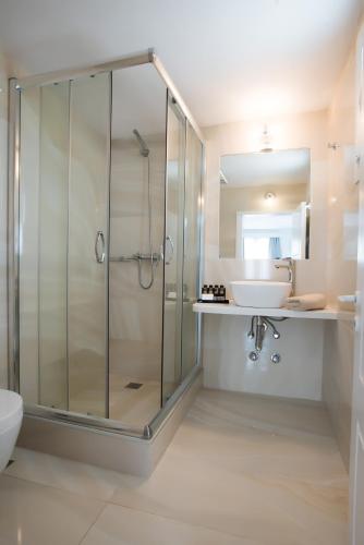 a bathroom with a shower and a sink at Hotel Charissi in Mýkonos City