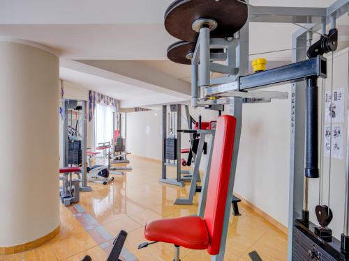 a gym with a row of tread machines at Hotel Cristina in Limone sul Garda