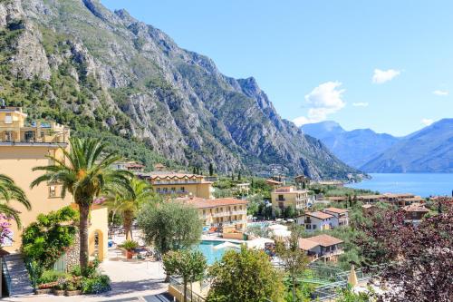 a view of a town with mountains and a lake at Hotel Cristina in Limone sul Garda