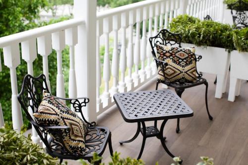 two chairs and a table on a porch at Hotel Passport Tbilisi in Tbilisi City