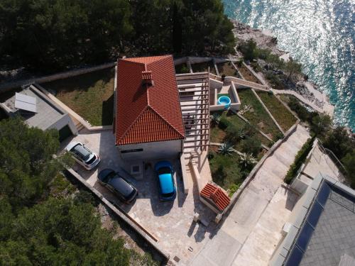 an aerial view of a house with cars parked in front at Villa Osibova in Milna