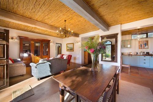 a living room with a table and a couch at Bartinney Private Cellar Banhoek in Stellenbosch