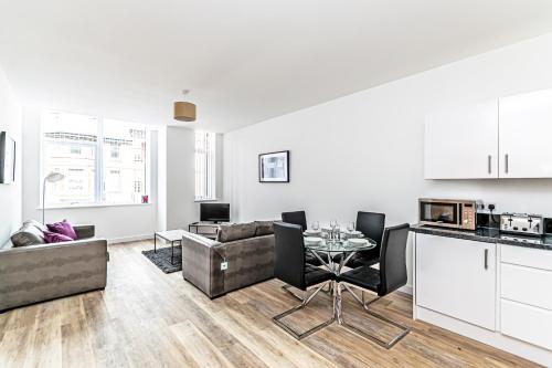 a living room with a couch and a table at City Suites by Guestz in Chester