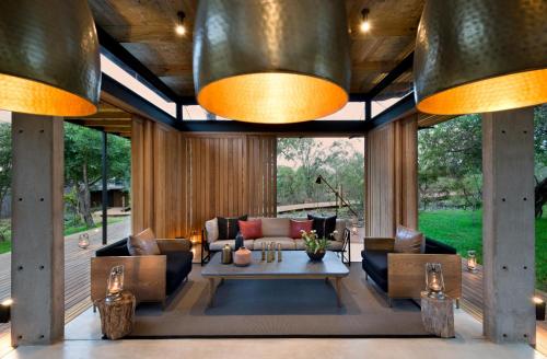 a living room with a couch and a table at Lion Sands Ivory Lodge in Sabi Sand Game Reserve