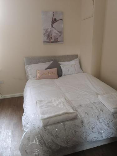a bed with towels on it in a bedroom at The Winter Garden Suites in Blackpool