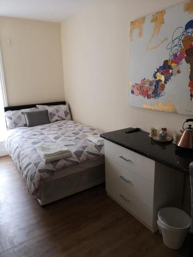 a bedroom with a bed and a dresser and a desk at The Winter Garden Suites in Blackpool