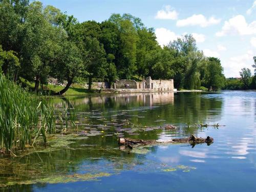 a body of water with a building in the distance at Apartments Korana, BelajskePoljice in Duga Resa