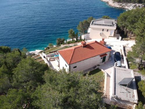 an aerial view of a house next to the water at Villa Osibova in Milna