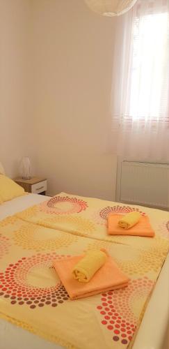 two towels are sitting on top of a bed at Apartments Korana, BelajskePoljice in Duga Resa