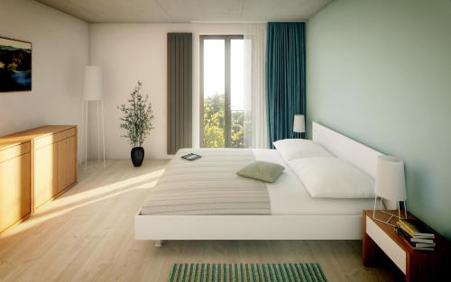 a white bedroom with a large bed and a window at Aparthotel Lípa in Krásná Lípa