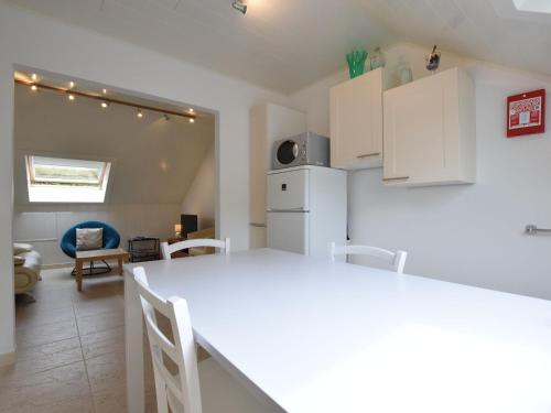 a kitchen with white cabinets and a white counter top at Quaint Apartment in Vielsalm with Private Terrace in Vielsalm