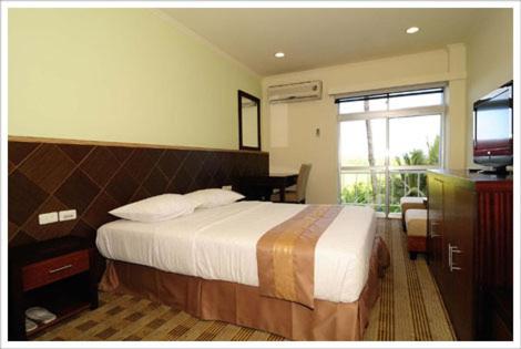 Ένα ή περισσότερα κρεβάτια σε δωμάτιο στο Airai Water Paradise Hotel & Spa