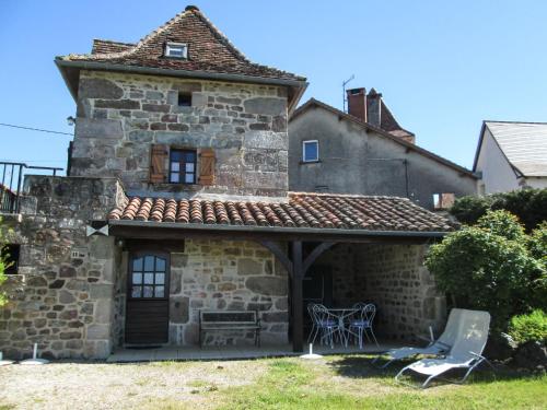 an outside view of a stone house with a patio at Holiday Home Le Pigeonnier by Interhome in La Valade