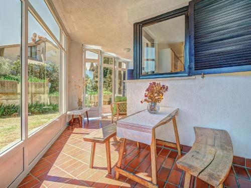 a porch with a table and chairs and windows at Apartment Iris Croatica by Interhome in Veruda