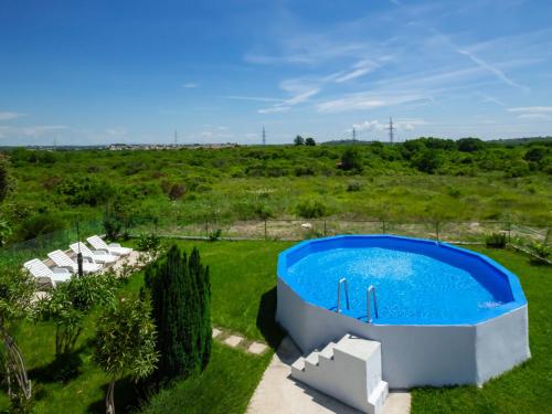 an overhead view of a swimming pool in a grassy field at Holiday Home Martina by Interhome in Valdebek