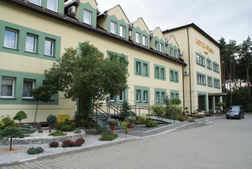 a large building on the side of a street at Hotel Wilga by Katowice Airport in Pyrzowice