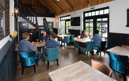 a group of people sitting at tables in a restaurant at Holiday rentals in Velsen-Zuid