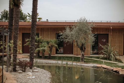 a house with a pond in front of a building at La Boheme Chambres in Lazise