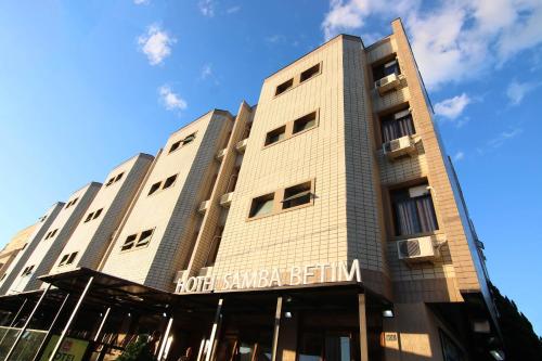 a building with a sign on the front of it at Samba Betim in Betim