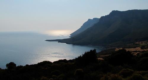 a view of a body of water with a mountain at Strongilos Homestay in Velanidia