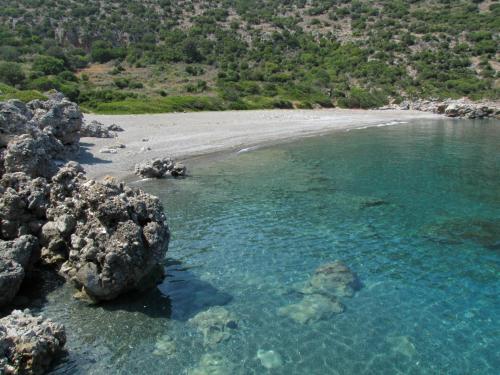 an aerial view of a beach with rocks and water at Strongilos Homestay in Velanidia