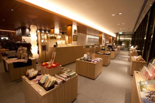 a store with a row of tables in a store at Chion-in Wajun Kaikan in Kyoto