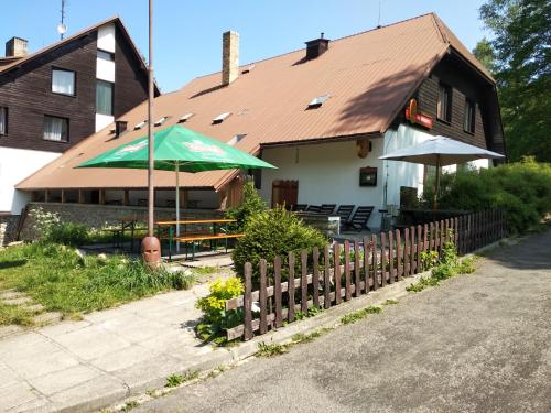 a house with a green umbrella in front of it at Na Losenici in Nicov