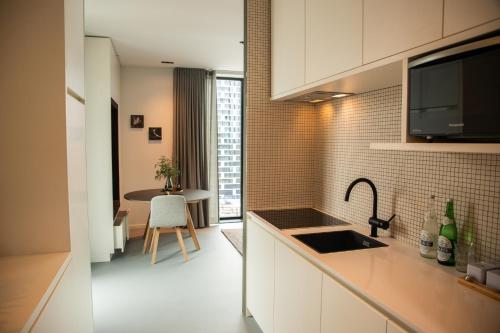 a kitchen with a sink and a counter top at CREATIVE VALLEY NEST – Luxury Rooftop Apartments in Utrecht