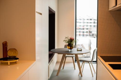 a small table in a kitchen with a window at CREATIVE VALLEY NEST – Luxury Rooftop Apartments in Utrecht