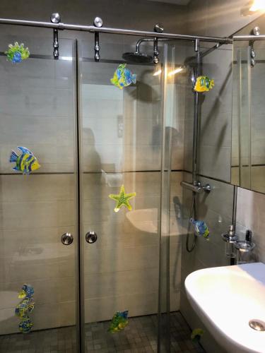 a shower with a glass door and a sink at APARTAMENTO JMHR 5 in Benajarafe