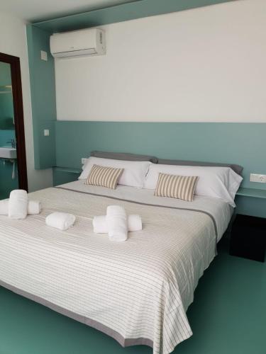 a bedroom with a large bed with towels on it at SubUp Hostel in Cabo de Palos