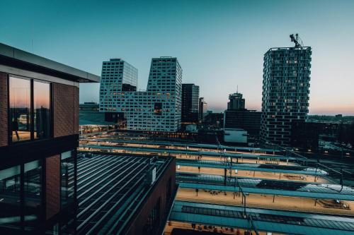a view of a city skyline with tall buildings at CREATIVE VALLEY NEST – Luxury Rooftop Apartments in Utrecht