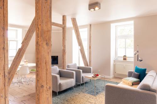 a living room with two couches and a tv at OSTKÜSTE - Villa Albatros Design Apartments in Ahlbeck