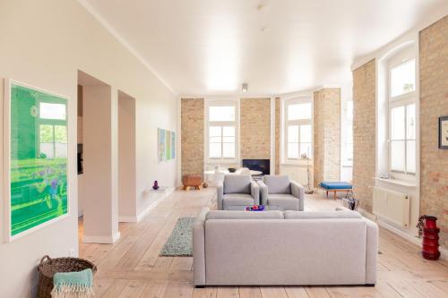 a living room with a couch and chairs in it at OSTKÜSTE - Villa Albatros Design Apartments in Ahlbeck