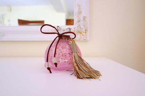 a pink bag with a bow on a table at PYRGOS RALLI ESTATE Guesthouse in Aegina Town