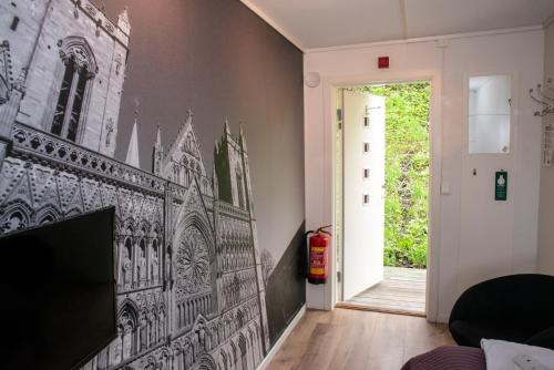 a drawing of a church on the wall in a living room at Sandmoen Bed & Breakfast, Free Parking in Trondheim