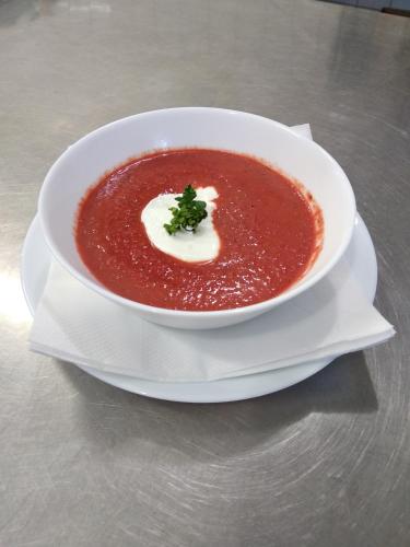 a bowl of tomato soup on a plate on a table at Na Losenici in Nicov