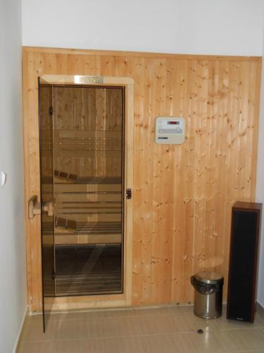 a wooden wall with a door in a room at Casa Domneasca in Curtea de Argeş