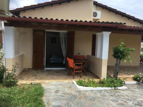 a house with a patio with a table and chairs at Villa Panorea in Moraitika