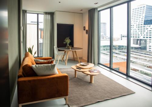 a living room with a couch and a table at CREATIVE VALLEY NEST – Luxury Rooftop Apartments in Utrecht