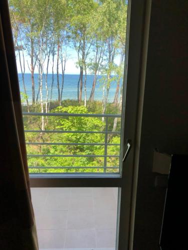 a view of the ocean from a bathroom window at Ledan in Chłopy