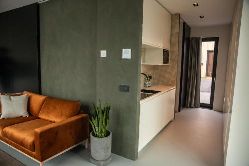 a living room with a couch and a kitchen at CREATIVE VALLEY NEST – Luxury Rooftop Apartments in Utrecht