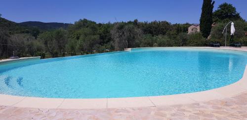 a large swimming pool with blue water at Poggio Al Palio in San Lorenzo a Merse