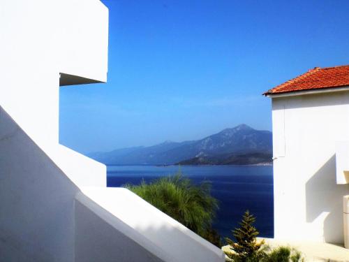 a white building with a view of the water at Princessa Riviera Resort in Pythagoreio
