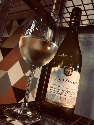 a glass of white wine next to a bottle of wine at Best Western Plus Nottingham Westminster Hotel in Nottingham