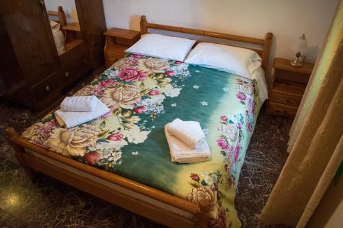 a bedroom with a bed with towels on it at Vaggelis Traditional House in Spetses