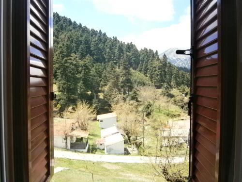 a window view of a mountain view from a house at The Magic Mountain in Tsapournia