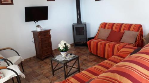 a living room with a couch and a table at TRUJILLO HOLIDAY HOME con PISCINA in Conil de la Frontera