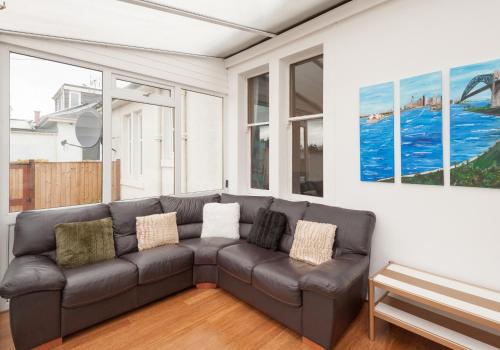 a living room with a couch and a painting at The Traquair Park Residence in Edinburgh